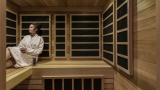 woman sitting and enjoying the sauna