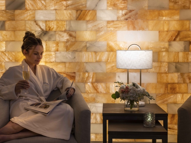 Spa waiting area with guest drinking champagne