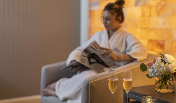woman relaxing in the spa with glasses of champagne