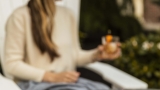 guest enjoying a cocktail outside by a firepit