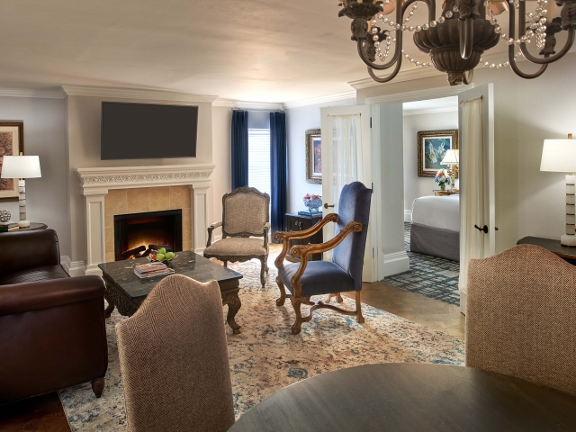 The living room area of the Breakers Suite, equipped with a fireplace.