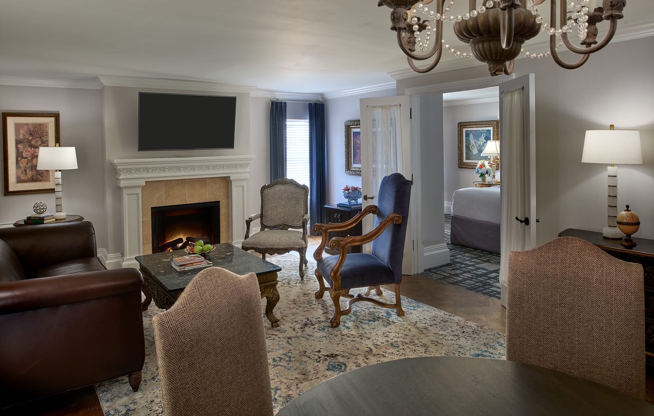 The Breakers Suite living room with a fireplace and plenty of seating.