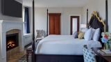 Interior view of the Estate Fireside bedroom with in-room fireplace.