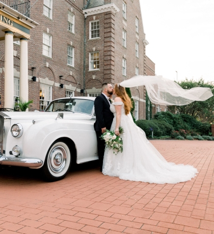 bride and groom in front of hotel viking building