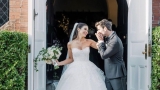 groom kissing bride's hand