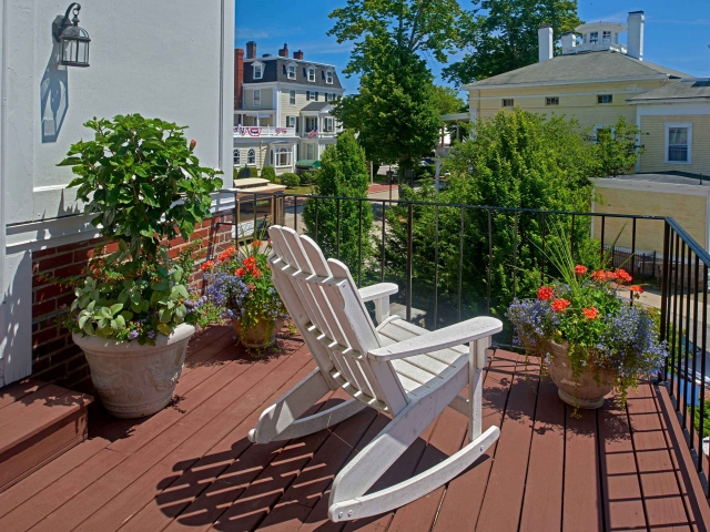 Deck with white rocking chair for the Kingscote Suite