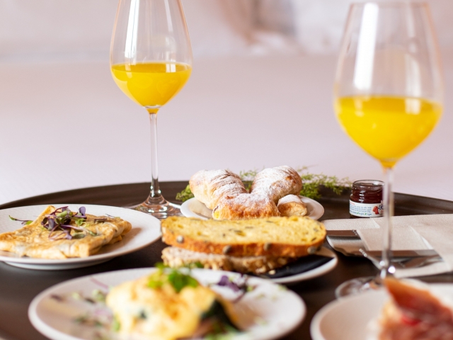 Breakfast in bed, complete with orange juice and omelettes.