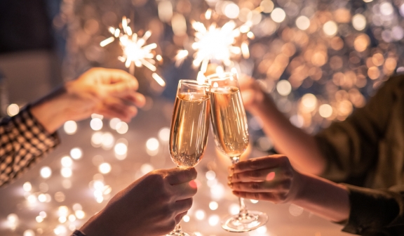 Hands of couple with flutes of champagne
