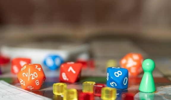 A board game with some figures and dice