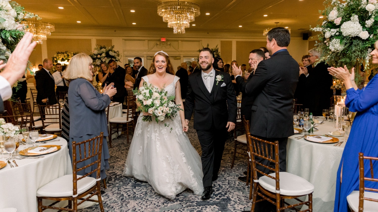 bride and groom entering reception hall